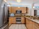 Stainless steel appliances complement the granite countertops and modern cabinetry in this kitchen at 6512 Midnight Pass Rd # 303, Sarasota, FL 34242