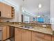 Beautiful kitchen featuring granite countertops and stainless steel sink at 6512 Midnight Pass Rd # 303, Sarasota, FL 34242