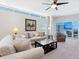 Bright living room featuring contemporary furnishings, a large window, and a balcony with ocean views at 6512 Midnight Pass Rd # 303, Sarasota, FL 34242