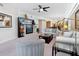 Spacious living room featuring an entertainment center, contemporary furnishings, and an open floor plan at 6512 Midnight Pass Rd # 303, Sarasota, FL 34242
