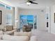 Cozy living room features contemporary furnishings, a large window, and a balcony with ocean views at 6512 Midnight Pass Rd # 303, Sarasota, FL 34242