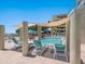 Serene community pool shaded by a sun sail with lounge chairs and tropical landscaping at 6512 Midnight Pass Rd # 303, Sarasota, FL 34242