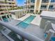 Upscale rectangular community pool with lounge chairs and umbrellas for residents to enjoy the Florida sun at 6512 Midnight Pass Rd # 303, Sarasota, FL 34242