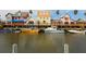 Waterfront view of colorful homes with boats docked along the canal at 6512 Midnight Pass Rd # 303, Sarasota, FL 34242