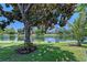 Beautiful backyard with a lake view and shady tree at 6539 Flycatcher Ln, Lakewood Ranch, FL 34202