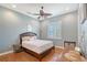 This cozy bedroom features a leaf fan, shuttered window, and hardwood floors, offering a comfortable and stylish space at 6539 Flycatcher Ln, Lakewood Ranch, FL 34202