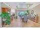 Dining area featuring stone floors and a large sliding glass door to the outdoor patio at 6539 Flycatcher Ln, Lakewood Ranch, FL 34202