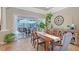 Charming dining area with stone floors and views of the outside entertaining area at 6539 Flycatcher Ln, Lakewood Ranch, FL 34202