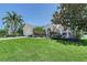 Charming single-story home featuring a well-manicured lawn and mature tropical landscaping at 6539 Flycatcher Ln, Lakewood Ranch, FL 34202