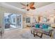 Sunlit living room with large sliding glass doors leading to the outdoor patio and kitchen views at 6539 Flycatcher Ln, Lakewood Ranch, FL 34202
