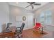 A well-lit home office featuring hardwood floors, a desk, and a comfortable seating area, perfect for remote work or study at 6539 Flycatcher Ln, Lakewood Ranch, FL 34202