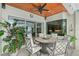 Covered patio with ceiling fan, views of the backyard, and outdoor dining space at 6539 Flycatcher Ln, Lakewood Ranch, FL 34202