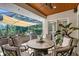 Covered patio has ample seating, ceiling fan, and screened in pool in backyard at 6539 Flycatcher Ln, Lakewood Ranch, FL 34202