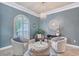 Cozy seating area with large window, chandelier, and stylish decor at 6539 Flycatcher Ln, Lakewood Ranch, FL 34202