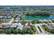 Aerial view of the house in a lakeside community with mature trees at 6605 38Th E Ln, Sarasota, FL 34243