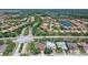 Aerial view of a residential neighborhood with lush greenery and a beautiful pond at 6605 38Th E Ln, Sarasota, FL 34243