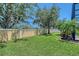 Green backyard with privacy wall and manicured lawn at 6605 38Th E Ln, Sarasota, FL 34243
