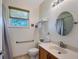 Bright bathroom with wood cabinets, granite countertops, and chrome fixtures at 6605 38Th E Ln, Sarasota, FL 34243