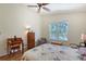 Comfortable bedroom with wood floors, ceiling fan, and view of backyard pool at 6605 38Th E Ln, Sarasota, FL 34243