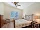 Bedroom with high ceilings, ceiling fan, and view of the screened pool at 6605 38Th E Ln, Sarasota, FL 34243