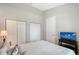 Clean bedroom with two closets, gray walls, and a television at 6605 38Th E Ln, Sarasota, FL 34243