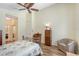 Cozy bedroom with hardwood floors, neutral walls, ceiling fan, and closet at 6605 38Th E Ln, Sarasota, FL 34243
