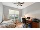 Well-lit bedroom features wood floors, white trim, and a ceiling fan at 6605 38Th E Ln, Sarasota, FL 34243