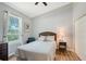 Cozy bedroom with hardwood floors, a queen bed, and view of the outdoors from the window at 6605 38Th E Ln, Sarasota, FL 34243
