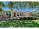 Inviting home exterior with manicured landscaping, a vibrant lawn, and mature trees for shade at 6605 38Th E Ln, Sarasota, FL 34243