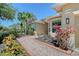 Charming home exterior featuring lush landscaping, a brick walkway, and a well-maintained lawn at 6605 38Th E Ln, Sarasota, FL 34243