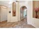 Elegant foyer featuring marble flooring, arched doorways, and decorative wall niches at 6605 38Th E Ln, Sarasota, FL 34243