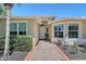 The front of the home featuring a red brick walkway leading to the front door at 6605 38Th E Ln, Sarasota, FL 34243