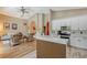 Modern kitchen featuring stainless steel appliances, white cabinets, and a breakfast bar at 6605 38Th E Ln, Sarasota, FL 34243