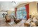 Cozy living room area with views into the dining and kitchen area and patio access via sliding glass doors at 6605 38Th E Ln, Sarasota, FL 34243