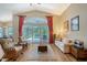 Bright living room featuring vaulted ceilings, hardwood floors and a sliding door to the lanai at 6605 38Th E Ln, Sarasota, FL 34243