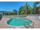 Beautiful community pool with ample lounge seating and clear blue skies above at 6605 38Th E Ln, Sarasota, FL 34243