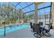 Beautiful backyard pool area with a screened enclosure and outdoor seating at 6605 38Th E Ln, Sarasota, FL 34243