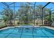 Sparkling swimming pool features built-in spa and screened enclosure with manicured backyard at 6605 38Th E Ln, Sarasota, FL 34243