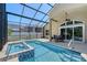 A screened lanai features a pool, hot tub, and outdoor seating at 6605 38Th E Ln, Sarasota, FL 34243