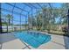 Beautiful screened pool and spa with lush landscaping and serene views of the backyard at 6605 38Th E Ln, Sarasota, FL 34243