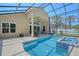 A screened lanai features a swimming pool, hot tub, and outdoor seating at 6605 38Th E Ln, Sarasota, FL 34243