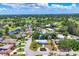 Beautiful aerial view of a residential community with lush greenery, waterfront homes, and a nearby golf course at 6931 Magellan Way, Sarasota, FL 34243