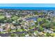 Panoramic aerial view showcasing a waterfront community with canals, green spaces, and stunning ocean views at 6931 Magellan Way, Sarasota, FL 34243