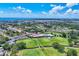 Picturesque aerial view of the golf course community with scenic water views in the distance at 6931 Magellan Way, Sarasota, FL 34243