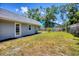Expansive backyard with well maintained lawn, partial fencing, and mature trees at 6931 Magellan Way, Sarasota, FL 34243