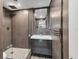 Modern bathroom featuring gray tiling, a glass-enclosed shower, and sleek vanity at 6931 Magellan Way, Sarasota, FL 34243