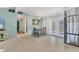 Inviting dining area featuring terrazzo floors and access to the outdoors through white French doors at 6931 Magellan Way, Sarasota, FL 34243