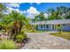 Charming single-story home with mature landscaping and a curving brick driveway at 6931 Magellan Way, Sarasota, FL 34243