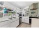 Bright kitchen featuring stainless steel appliances, white cabinetry, and modern countertops at 6931 Magellan Way, Sarasota, FL 34243