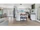 Well-lit open kitchen with stainless steel appliances and island seating open to living area at 6931 Magellan Way, Sarasota, FL 34243